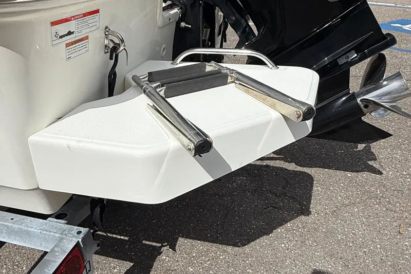 Slide: The Image of 2021 Boston Whaler 170 Montauk swim platform with ladder and outboard motor. - 13