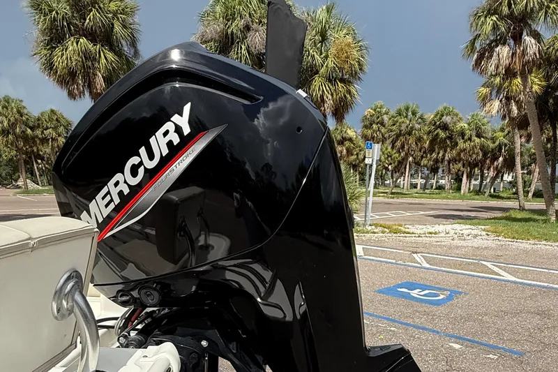Slide: The Image of Mercury outboard motor on 2021 Boston Whaler 170 Montauk, parked near palm trees. - 15
