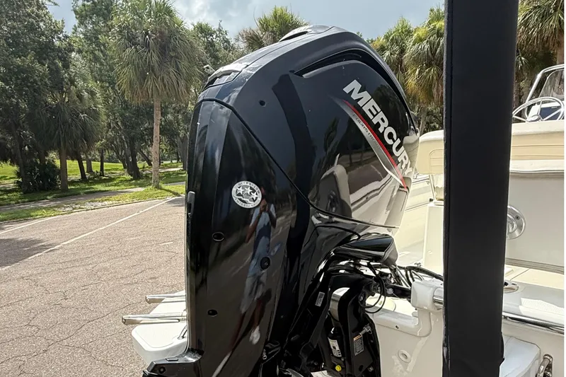 Slide: The Image of Mercury outboard engine on 2021 Boston Whaler 170 Montauk, parked near palm trees. - 17