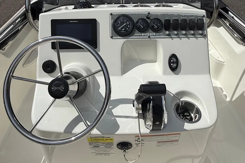Slide: The Image of 2021 Boston Whaler 170 Montauk boat console with steering wheel and controls. - 22