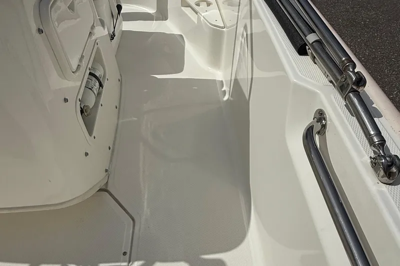 Slide: The Image of Interior view of a 2021 Boston Whaler 170 Montauk boat, featuring clean white surfaces. - 23