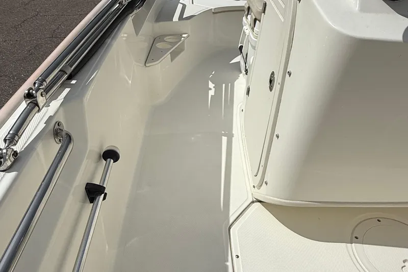 Slide: The Image of 2021 Boston Whaler 170 Montauk interior, showcasing clean deck and stainless steel fittings. - 24