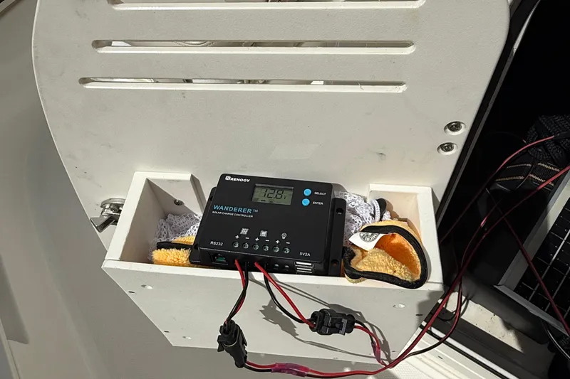 Slide: The Image of Solar charge controller on a 2021 Boston Whaler 170 Montauk boat, with connected wires. - 26