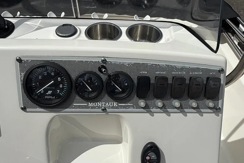 Slide: The Image of Dashboard of a 2021 Boston Whaler 170 Montauk boat with gauges and switches. - 28