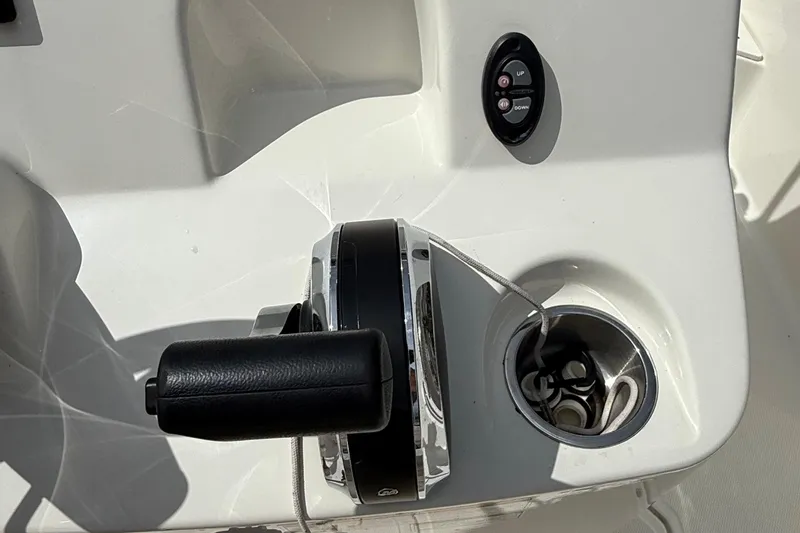 Slide: The Image of Control panel of a 2021 Boston Whaler 170 Montauk boat, featuring throttle and cup holder. - 29