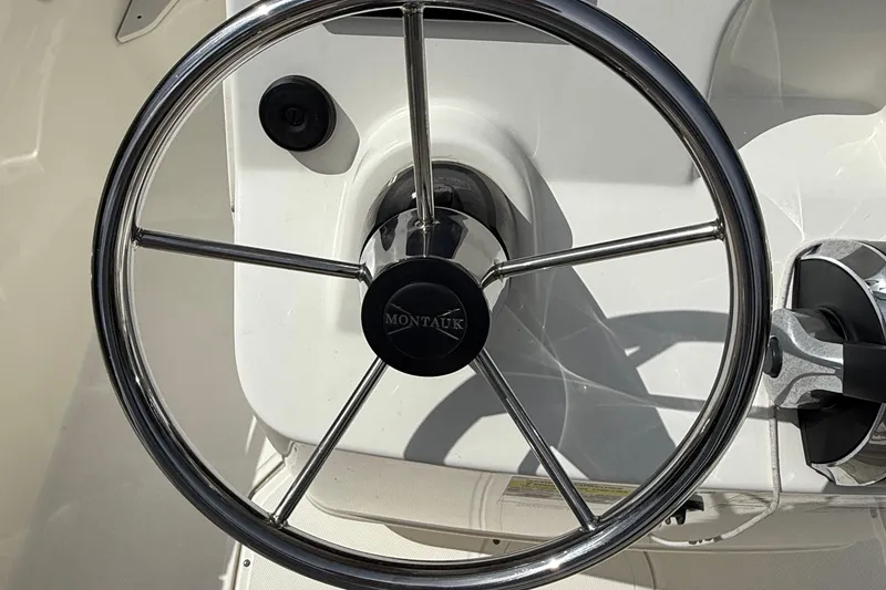 Slide: The Image of Steering wheel of 2021 Boston Whaler 170 Montauk boat, close-up view. - 30