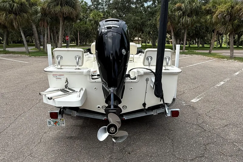 Slide: The Image of 2021 Boston Whaler 170 Montauk boat with outboard motor in a parking lot. - 4