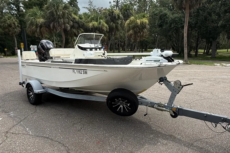 Slide: The Image of 2021 Boston Whaler 170 Montauk boat on trailer in a park setting. - 7