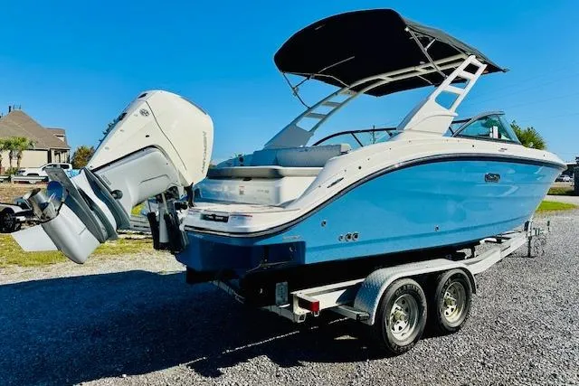 Slide: The Image of 2026 Sea Ray SPX 230 Outboard boat on trailer, blue hull, sunny day. - 1