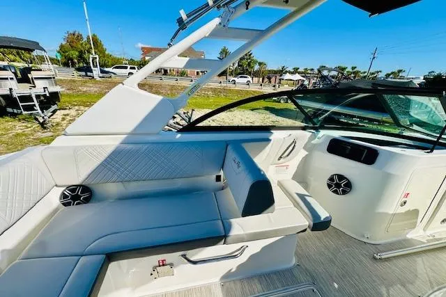 Slide: The Image of 2026 Sea Ray SPX 230 Outboard boat interior with white seating and modern dashboard. - 10