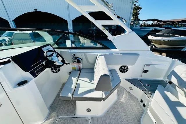 Slide: The Image of 2026 Sea Ray SPX 230 Outboard boat interior with modern seating and steering console. - 11