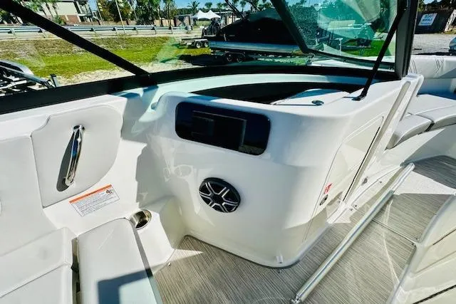 Slide: The Image of 2026 Sea Ray SPX 230 Outboard boat interior with modern dashboard and seating. - 13