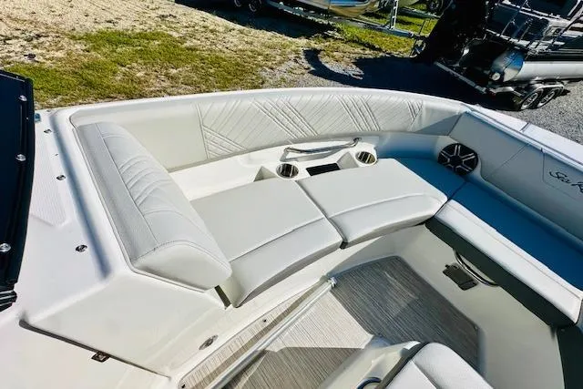 Slide: The Image of 2026 Sea Ray SPX 230 Outboard boat interior with plush seating and cup holders. - 17
