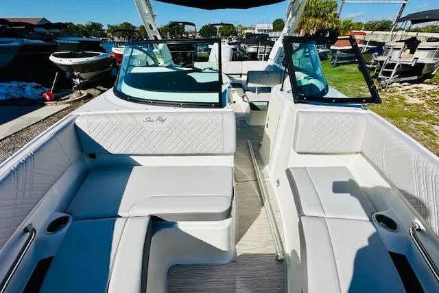 Slide: The Image of 2026 Sea Ray SPX 230 Outboard boat interior with white seating and open deck layout. - 19
