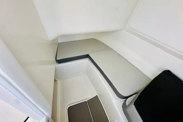 Slide: The Image of 2026 Sea Ray SPX 230 Outboard cabin interior with sleek, modern seating design. - 20