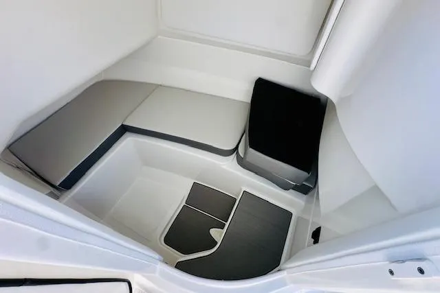 Slide: The Image of 2026 Sea Ray SPX 230 Outboard interior cabin with cushioned seating and modern design. - 21