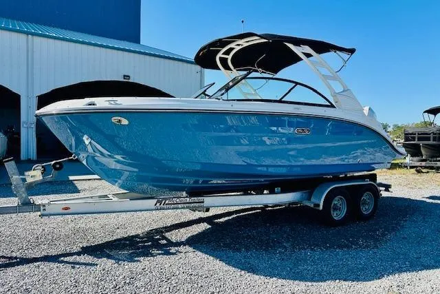 Slide: The Image of 2026 Sea Ray SPX 230 Outboard boat on trailer, blue hull, parked outdoors. - 3