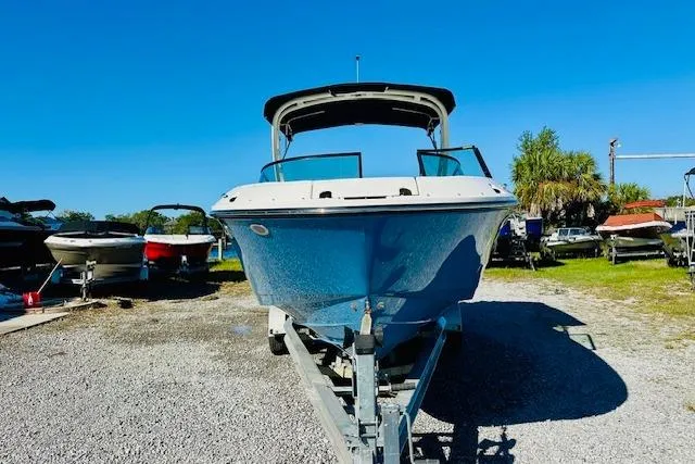 Slide: The Image of 2026 Sea Ray SPX 230 Outboard boat on trailer, parked outdoors under clear blue sky. - 4