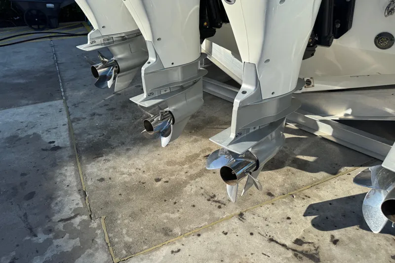 Slide: The Image of 2023 Formula 400 Super Sport Crossover boat engines with propellers on concrete surface. - 21