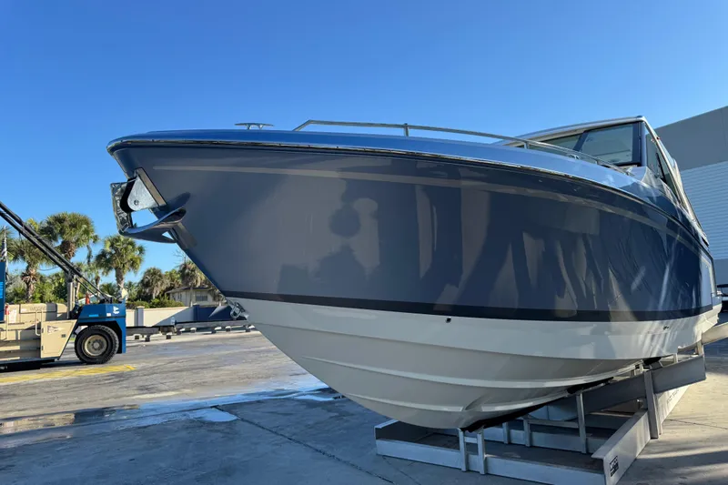Slide: The Image of 2023 Formula 400 Super Sport Crossover boat on display under clear blue sky. - 31
