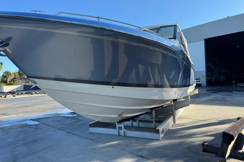 Slide: The Image of 2023 Formula 400 Super Sport Crossover boat on a dock, side view. - 32