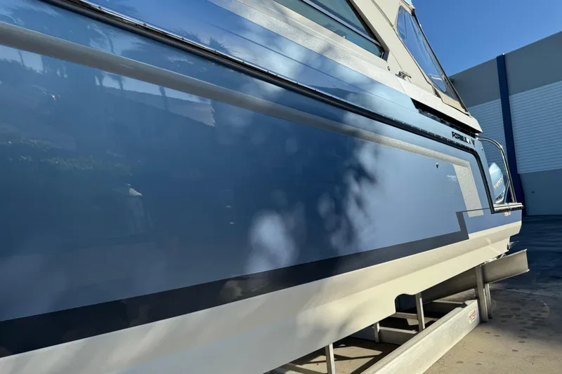 Slide: The Image of 2023 Formula 400 Super Sport Crossover boat side view in sunlight. - 36