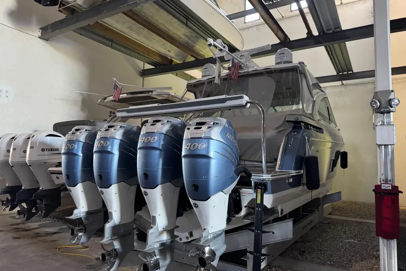 Slide: The Image of 2023 Formula 400 Super Sport Crossover with multiple outboard engines in a storage facility. - 87