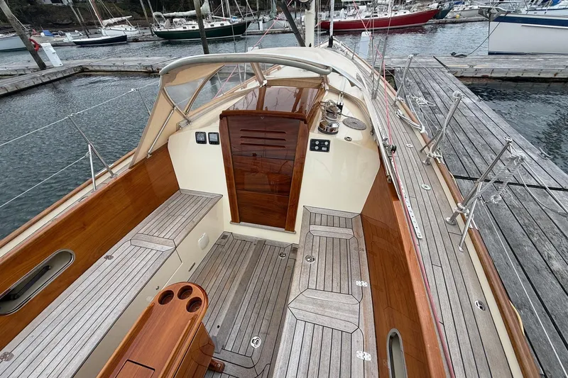Slide: The Image of Hinckley DS 42 sailboat, 2015 model, featuring elegant wooden deck and spacious cockpit. - 11