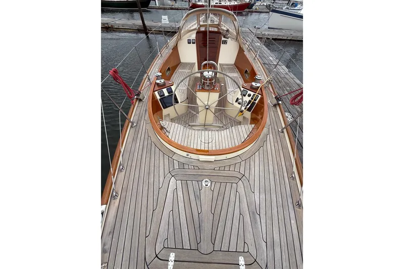 Slide: The Image of 2015 Hinckley DS 42 sailboat deck with wooden finish and steering wheel. - 12