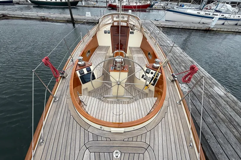 Slide: The Image of Hinckley DS 42 sailboat, 2015 model, docked with wooden deck and steering wheel. - 13