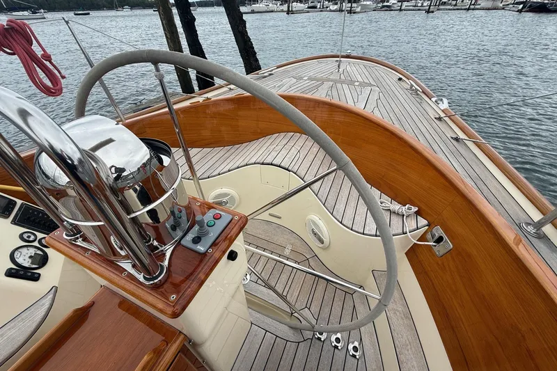 Slide: The Image of 2015 Hinckley DS 42 yacht deck with wooden finish and steering wheel. - 16