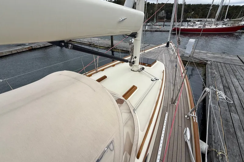 Slide: The Image of Hinckley DS 42 sailboat, 2015 model, docked at a marina with wooden deck details. - 19