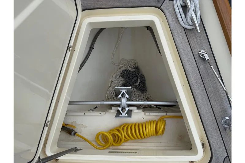 Slide: The Image of Hinckley DS 42 (2015) boat storage compartment with ropes and coiled yellow hose. - 21