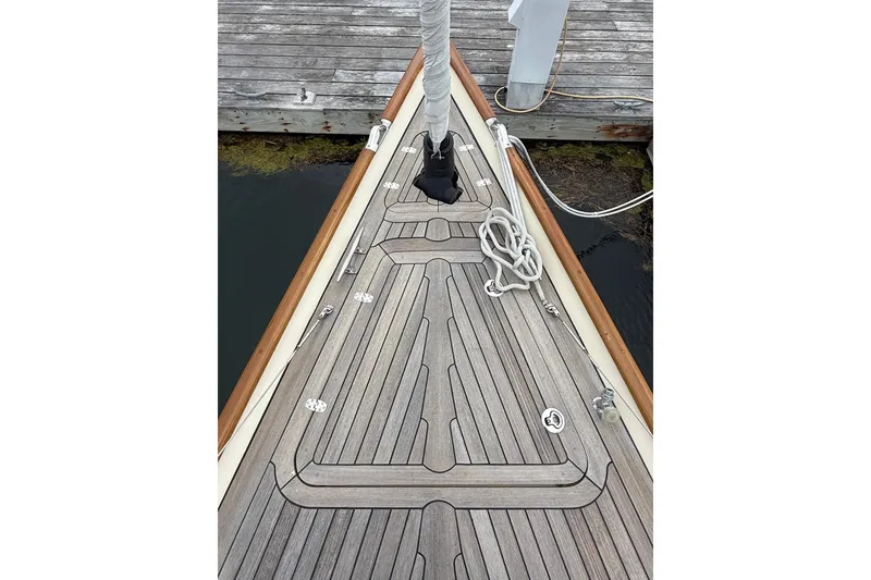 Slide: The Image of Hinckley DS 42 sailboat deck, 2015 model, docked with wooden planks and coiled rope. - 22