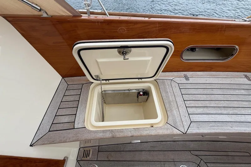 Slide: The Image of Open storage compartment on 2015 Hinckley DS 42 yacht deck, featuring wood and metal finishes. - 36