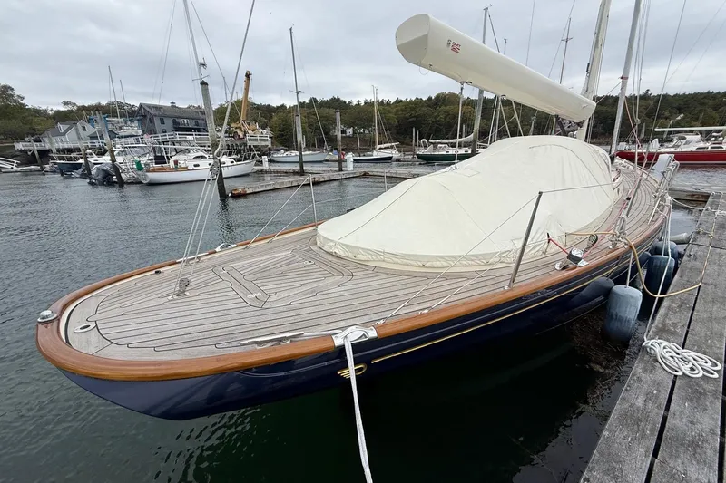 Slide: The Image of 2015 Hinckley DS 42 sailboat docked at a marina, featuring a sleek wooden deck. - 4