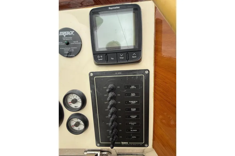 Slide: The Image of Control panel of a 2015 Hinckley DS 42 boat with gauges and switches. - 44