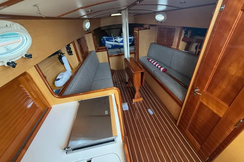 Slide: The Image of Interior of 2015 Hinckley DS 42 sailboat with wooden finishes and seating area. - 50