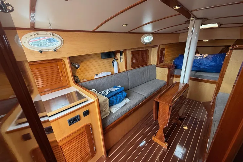 Slide: The Image of Interior of 2015 Hinckley DS 42 yacht with wooden finishes and cozy seating area. - 51
