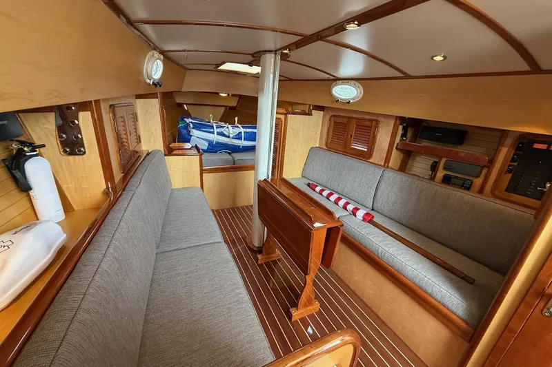 Slide: The Image of Interior of 2015 Hinckley DS 42 sailboat with wooden finishes and seating area. - 53