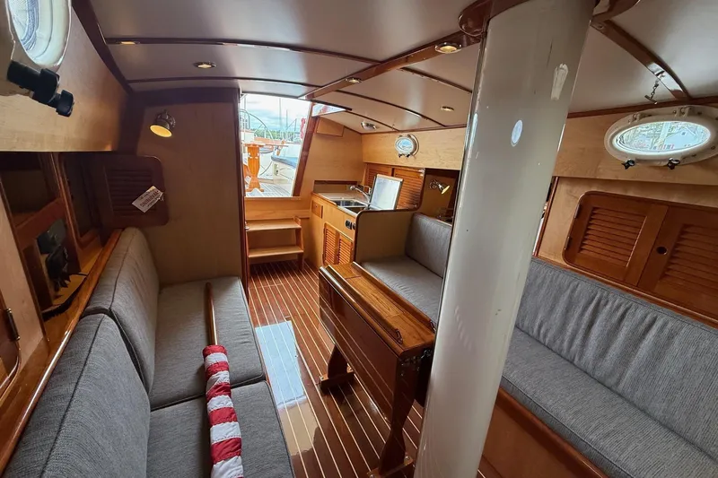 Slide: The Image of Interior of 2015 Hinckley DS 42 sailboat with wooden finishes and cozy seating. - 56