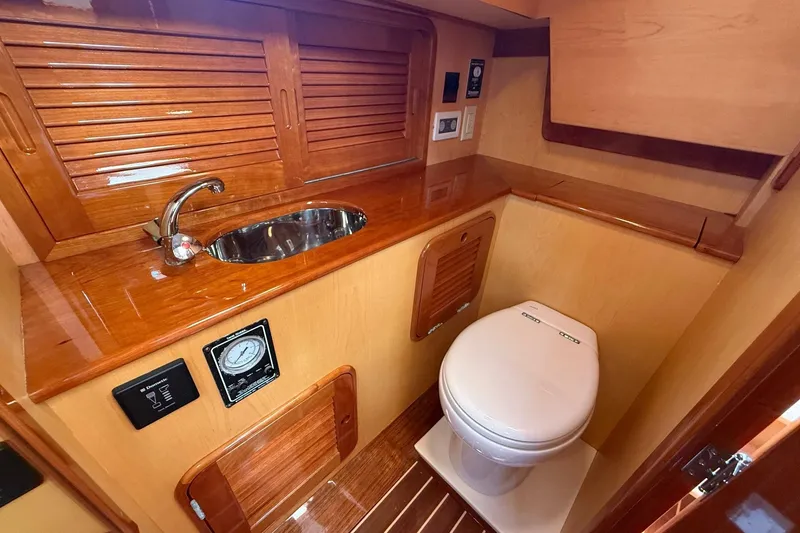Slide: The Image of Luxurious 2015 Hinckley DS 42 yacht bathroom with wooden cabinetry and modern fixtures. - 66