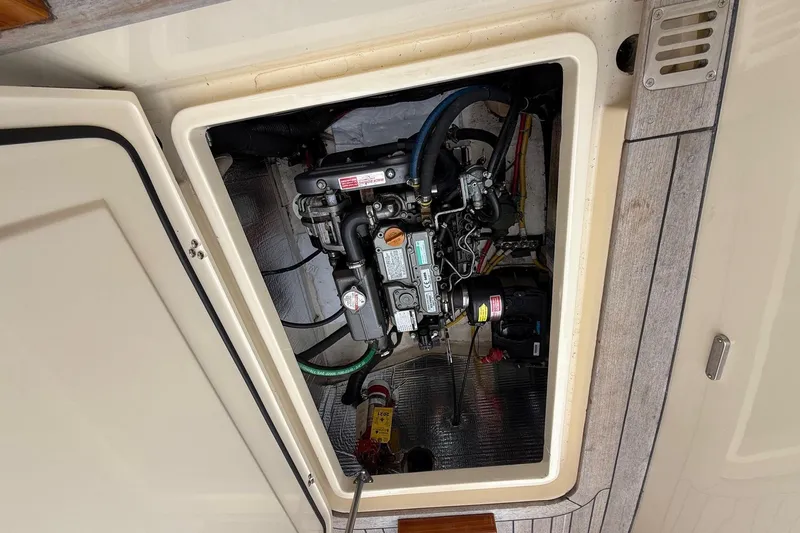 Slide: The Image of Engine compartment of a 2015 Hinckley DS 42 boat, showcasing mechanical components. - 77