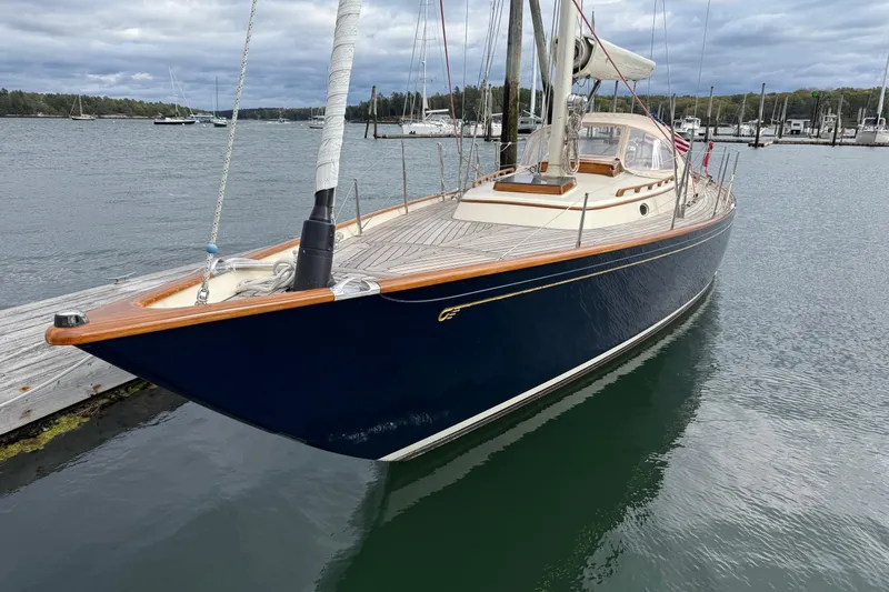 Slide: The Image of 2015 Hinckley DS 42 sailboat docked in a marina, featuring sleek design and wooden accents. - 1