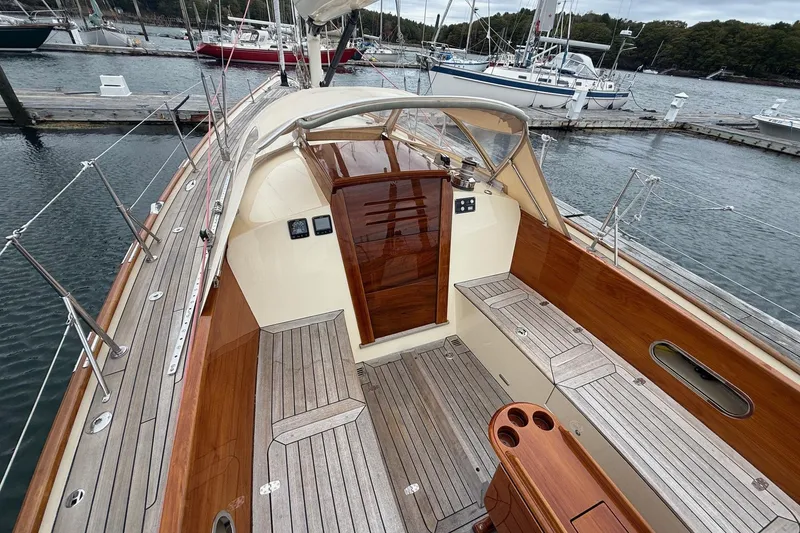 Slide: The Image of Hinckley DS 42 sailboat, 2015 model, featuring elegant wooden deck and spacious cockpit. - 10