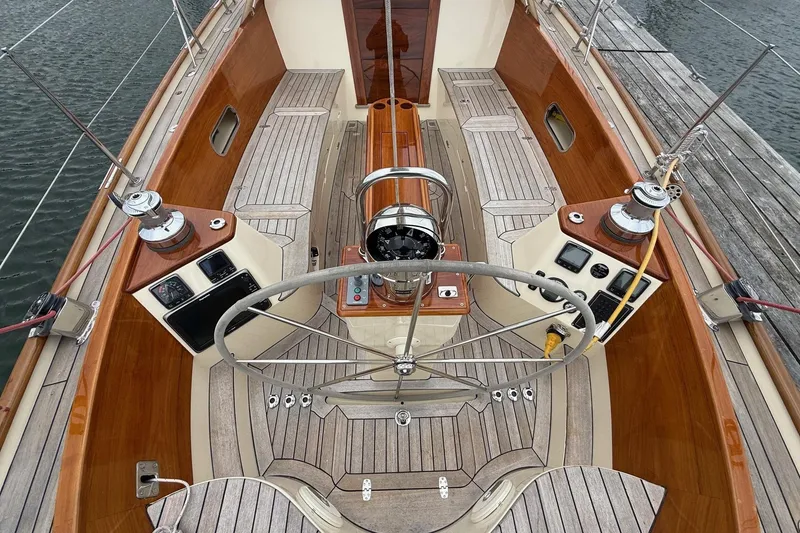 Slide: The Image of Hinckley DS 42 sailboat cockpit, 2015 model, featuring wooden accents and steering wheel. - 17