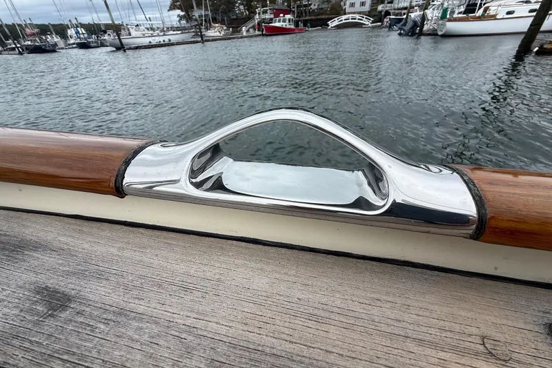 Slide: The Image of Polished metal fitting on 2015 Hinckley DS 42 yacht, docked in a marina. - 33