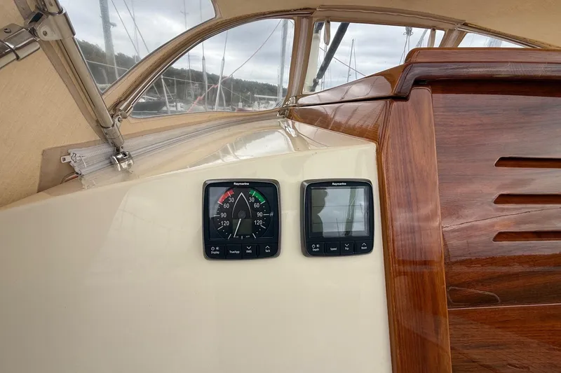 Slide: The Image of Hinckley DS 42 sailboat cockpit with Raymarine instruments, showcasing elegant woodwork, 2015 model. - 45