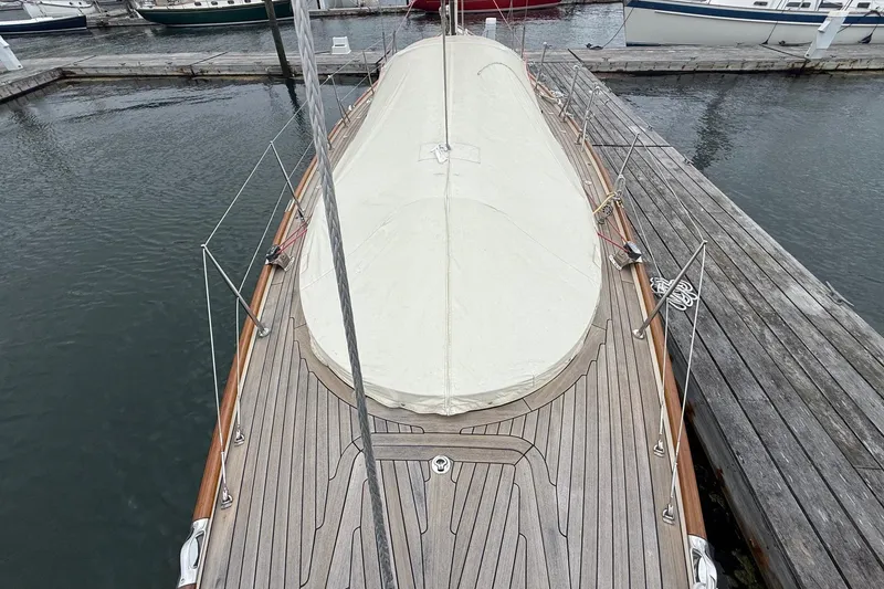 Slide: The Image of Hinckley DS 42 sailboat, 2015 model, docked with covered deck and wooden finish. - 5