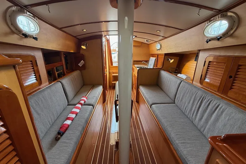 Slide: The Image of Interior of 2015 Hinckley DS 42 sailboat with wooden finish and gray seating. - 54